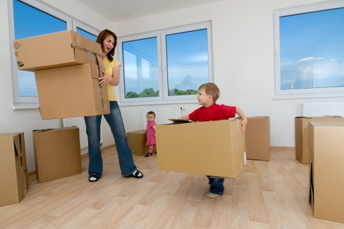 Trained moving staff using PPE while loading items into a van
